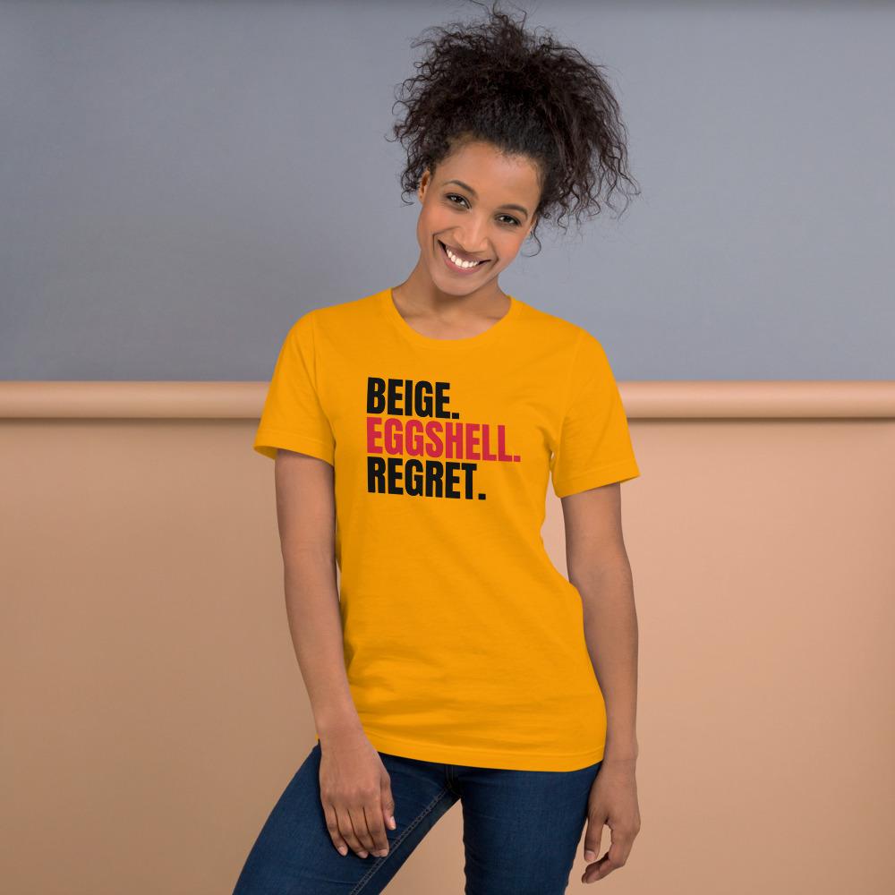 BEIGE. EGGSHELL. REGRET. — printed on a gold t-shirt