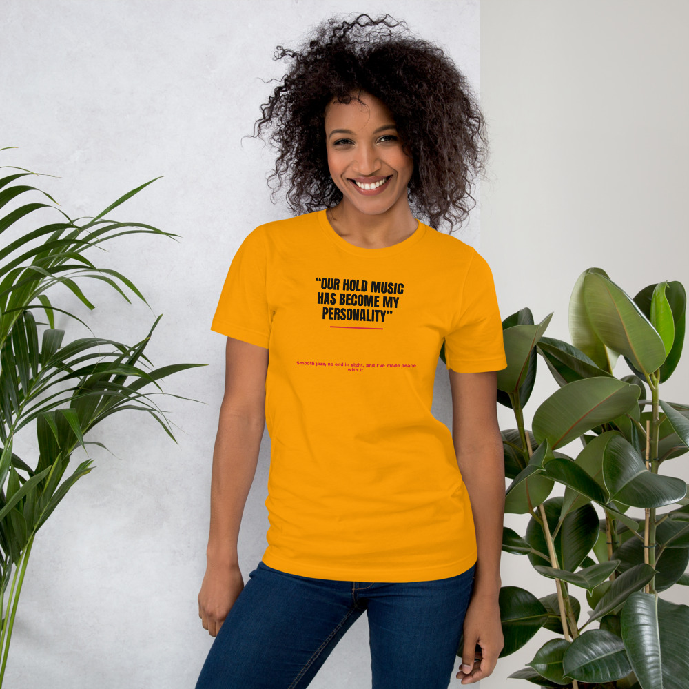 OUR HOLD MUSIC HAS BECOME MY PERSONALITY — printed on a gold t-shirt